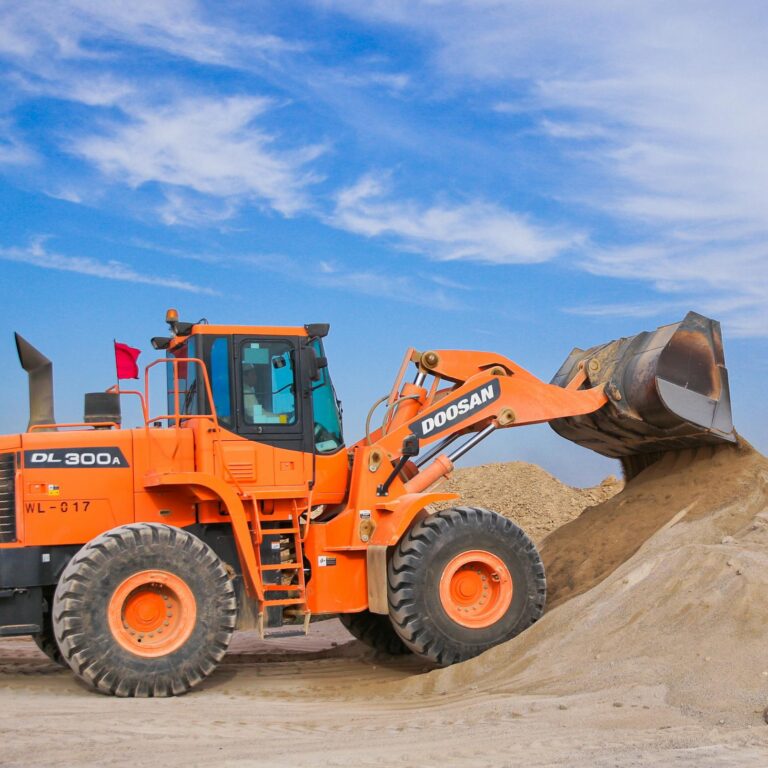 Orange Excavator on Brown Hill